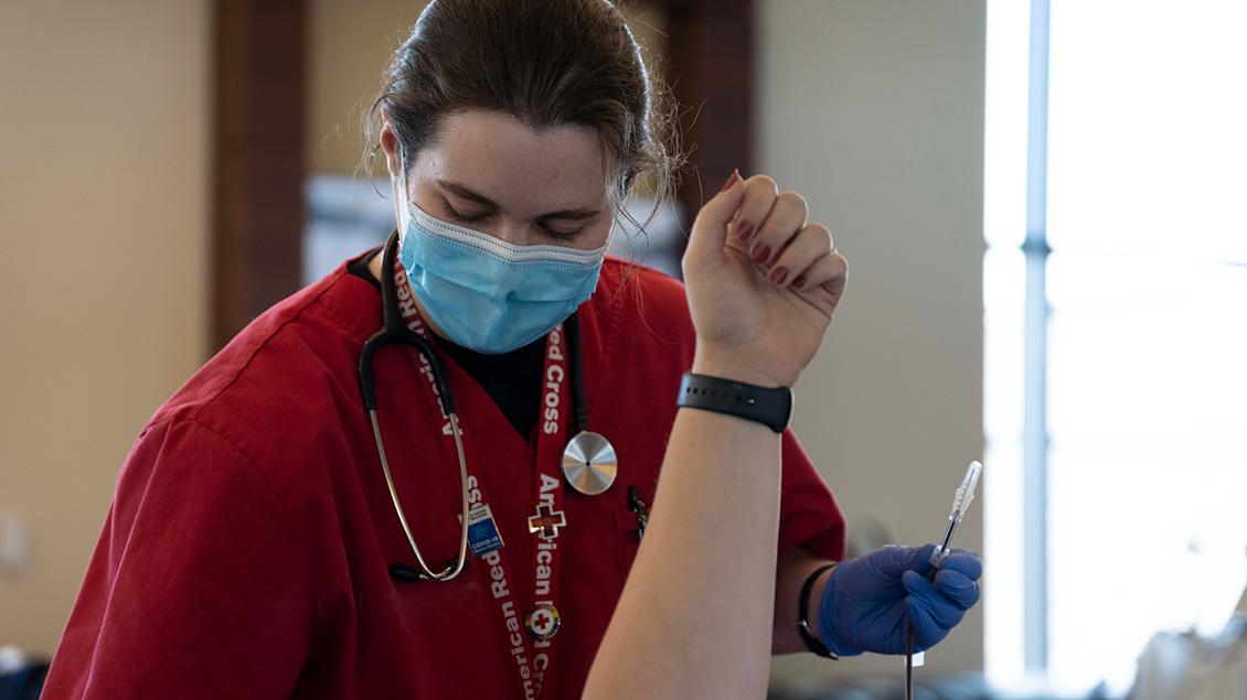 A nurse prepares to help someone donate blood
