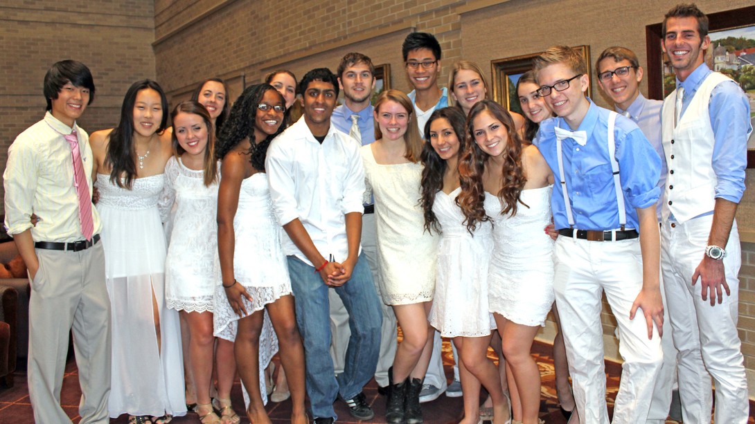 Group of young men and women wearing pale blue and white