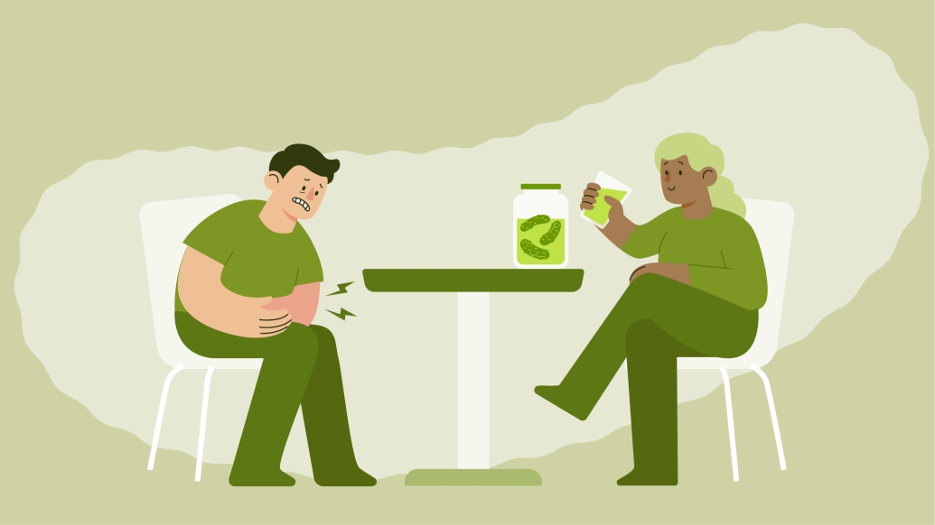 Graphic of a man and woman dressed in green sitting at a table that has a jar of pickles on it.