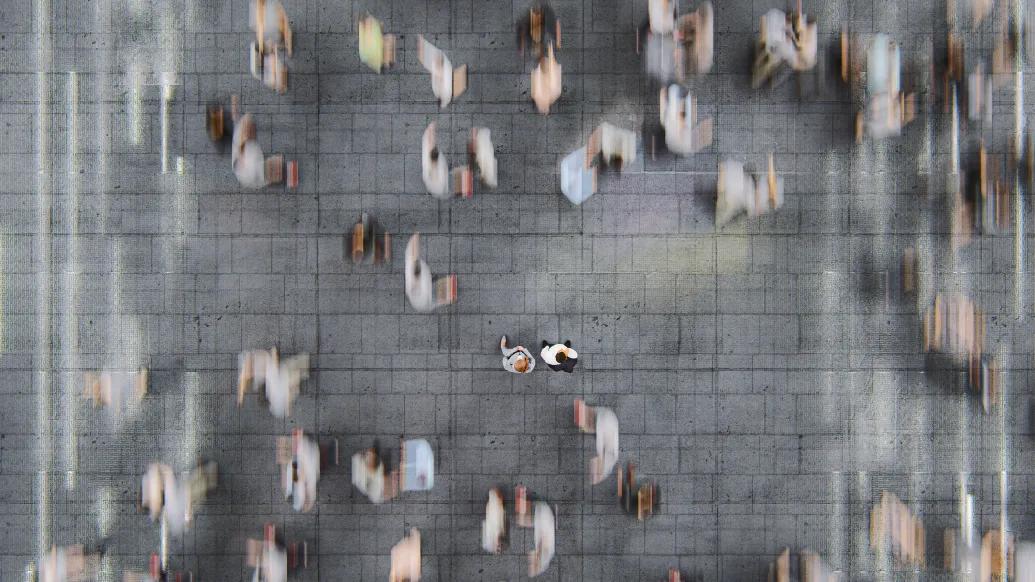 crowded blurred people walking in city streets
