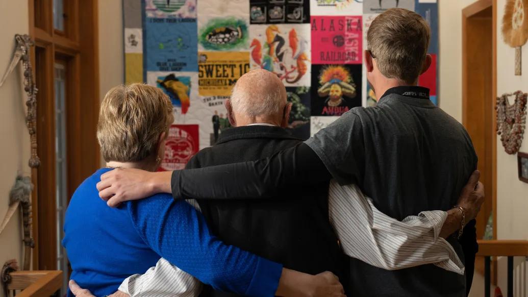 backs of three people