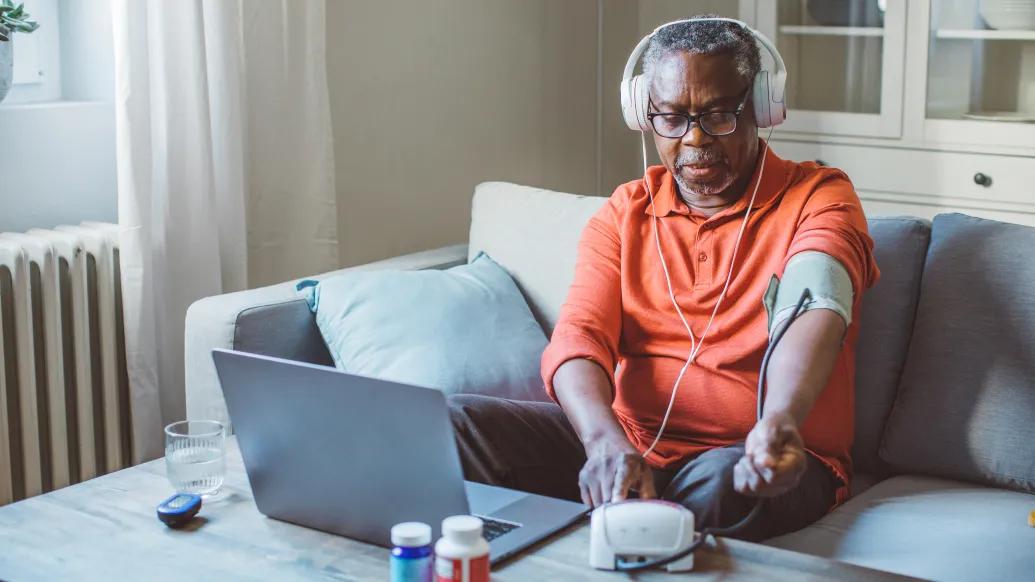 Senior Man Headphones Laptop Cuff
