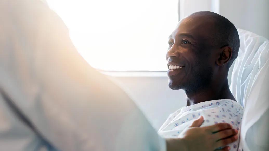 black male in hospital bed smiling