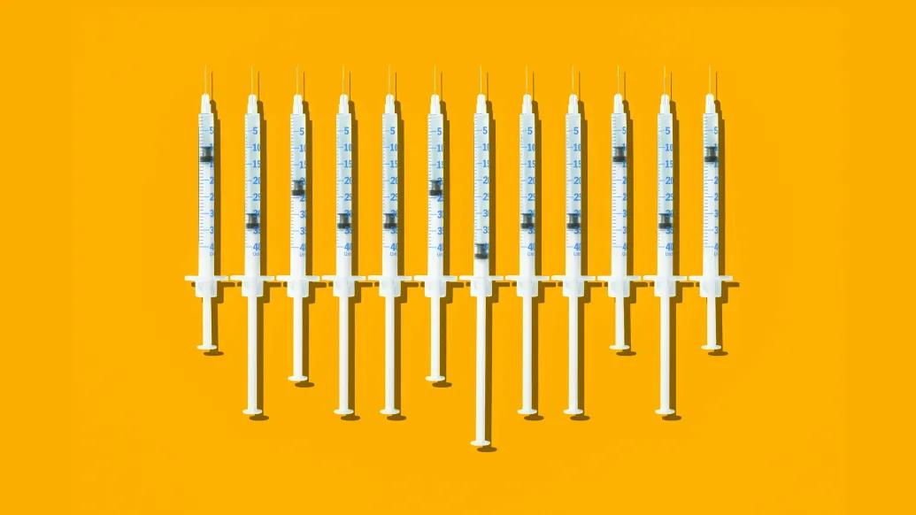 Syringes in a row on yellow backfround