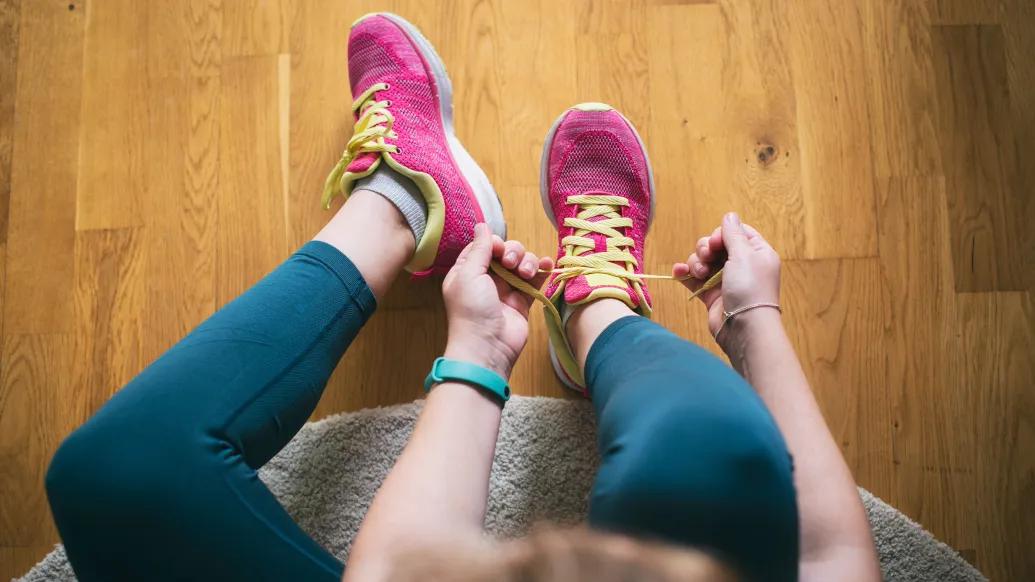 Person tying shoes on floor