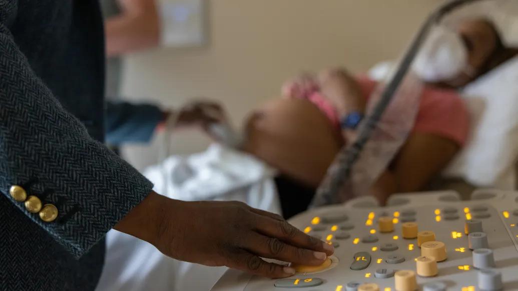 woman next to pregnant womens bed 