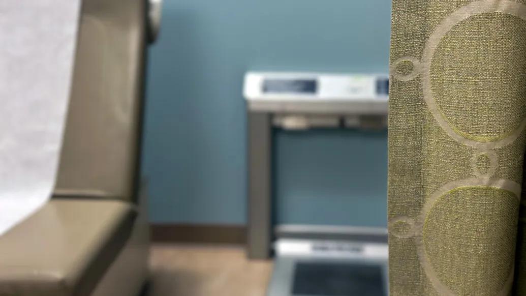 Scale pictured behind a hospital room curtain