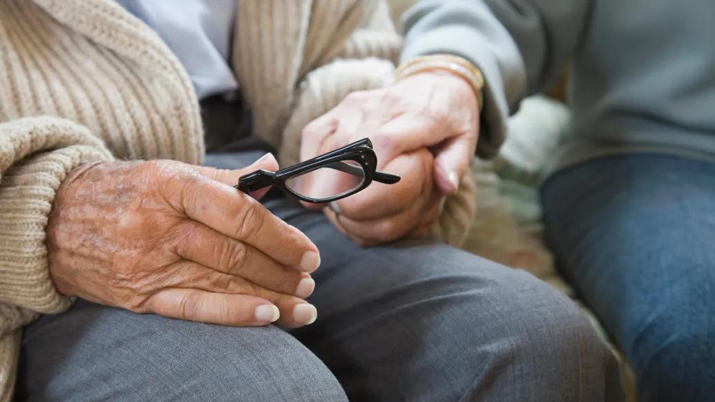 Older couple holding hands