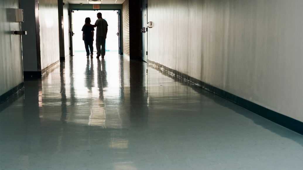 Photo of two silhouettes in a hallway 