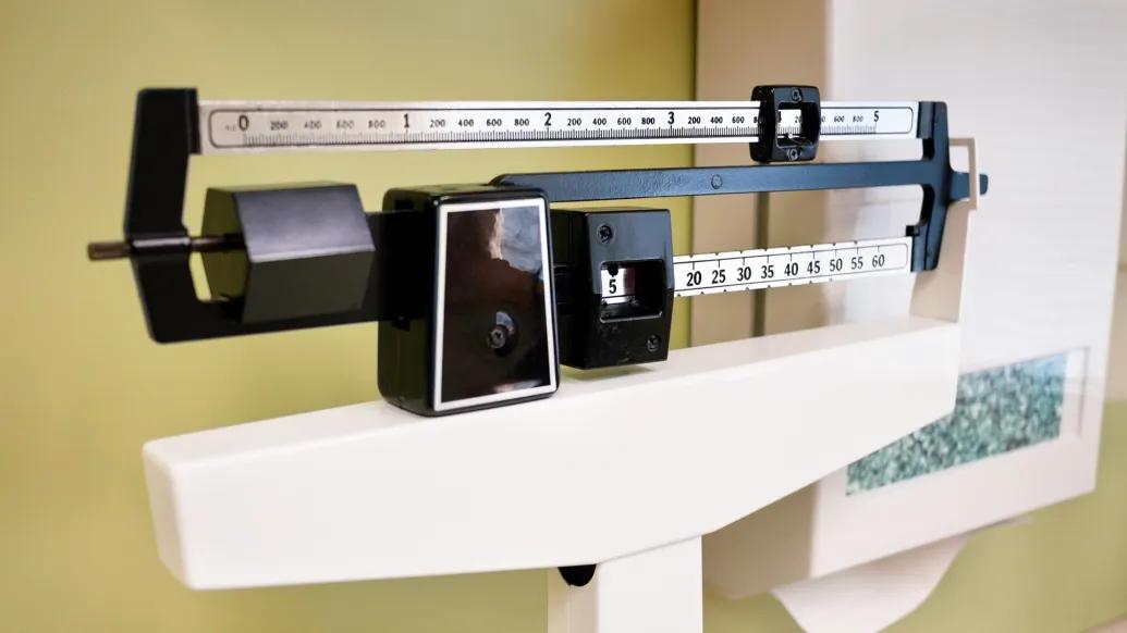 weight scale black white in exam room close up
