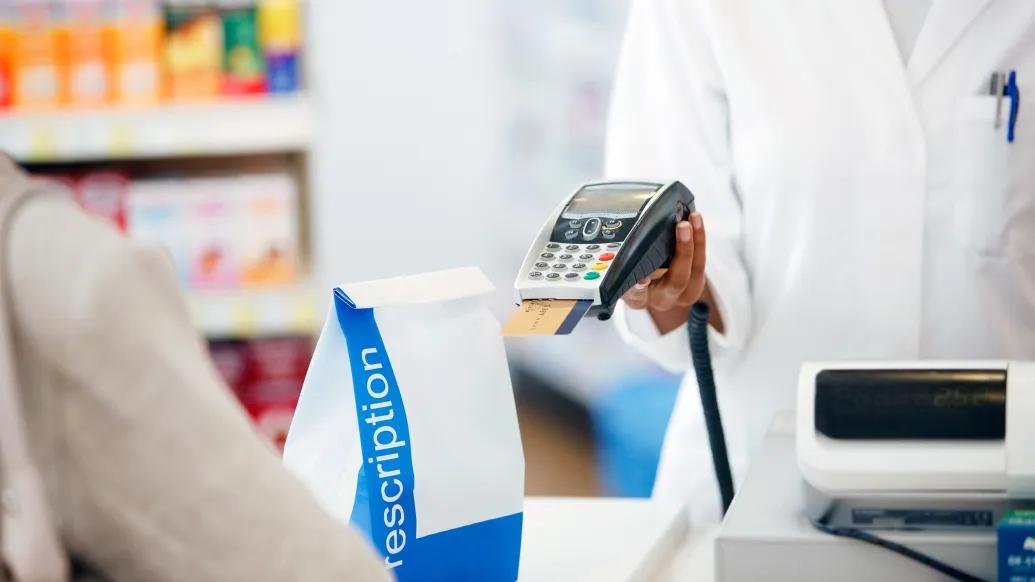 counter with credit card machine and white bag 