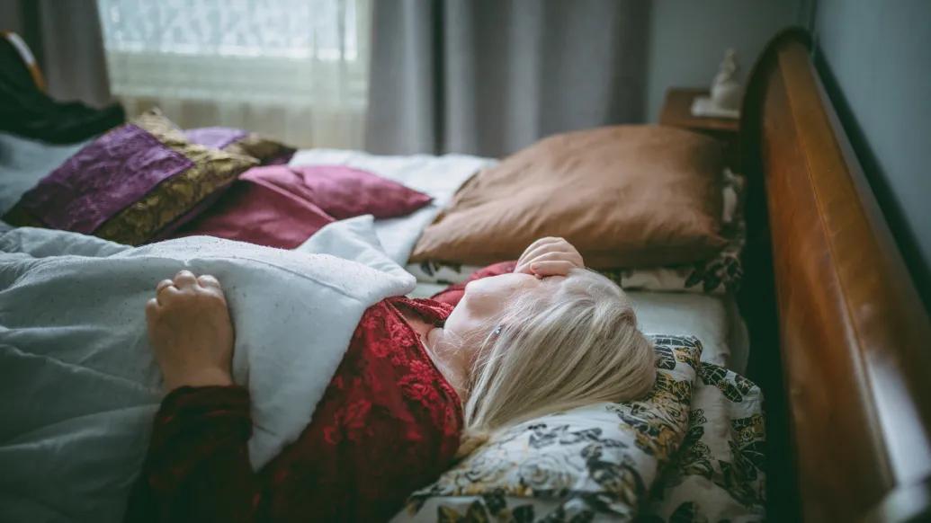 older woman lying in bed