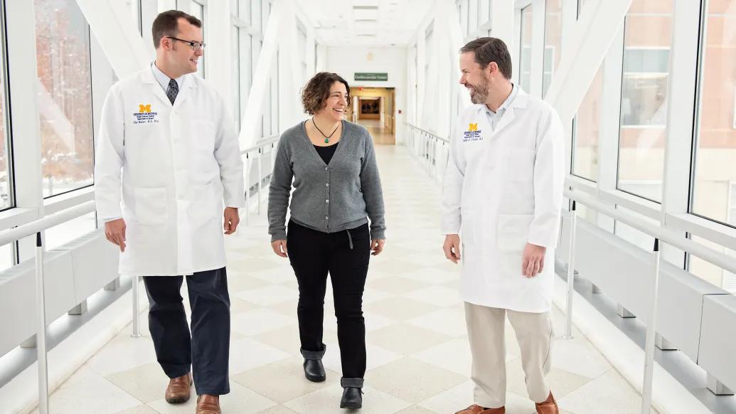doctors talking to eachother down a hallway