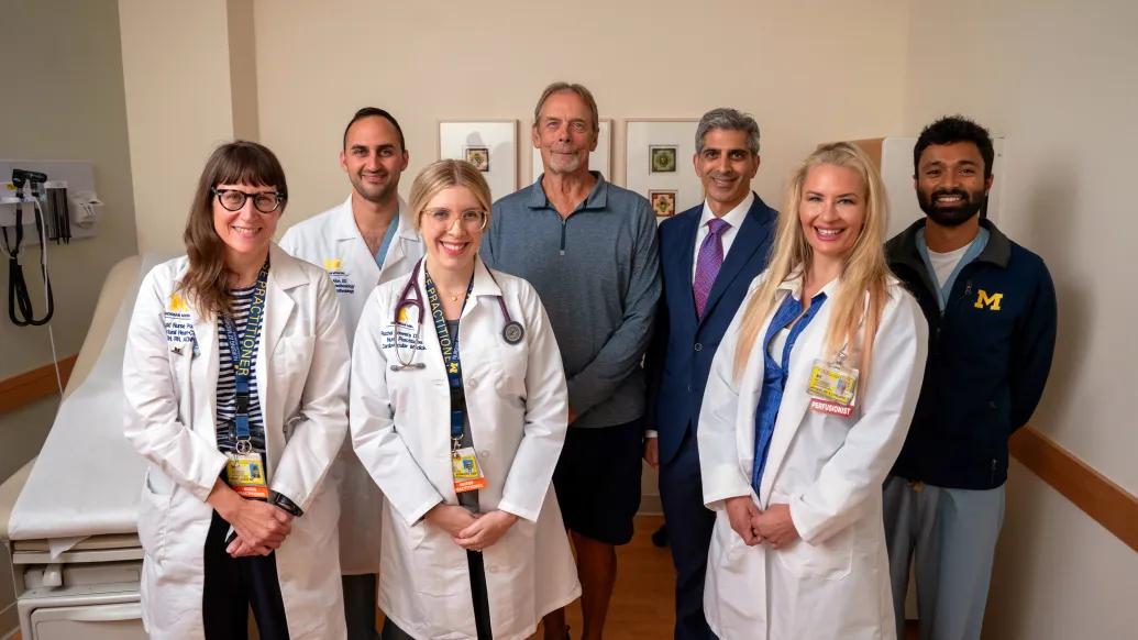 clinical team and patient standing together