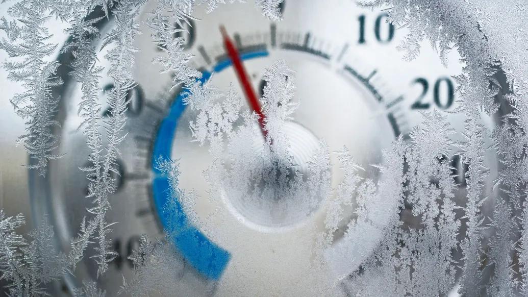 frozen dial with ice on it with red dial