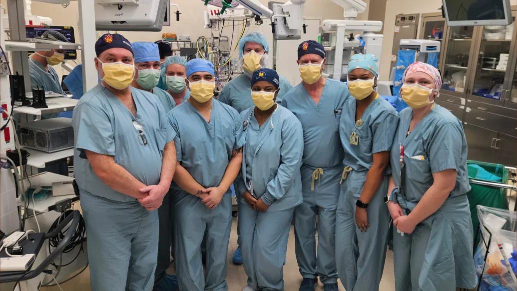 The surgical team poses in the OR after the first implantation for the trial at U-M.