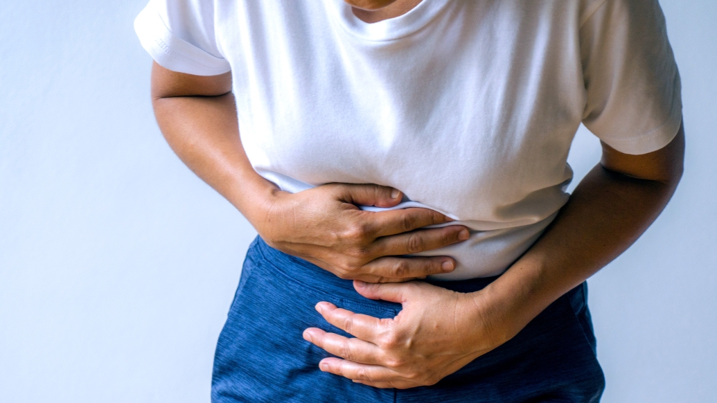 person bent over stomach holding 