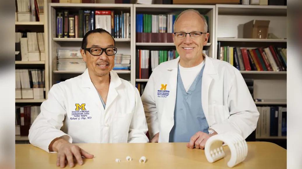 Richard Ohye, M.D., and Glenn Green, M.D., from Michigan Medicine and University of Michigan Health C.S. Mott Children’s Hospital with a bioresorbable, 3D-printed tracheobronchial splint device educational model – original size (left) and augmented model (right) 