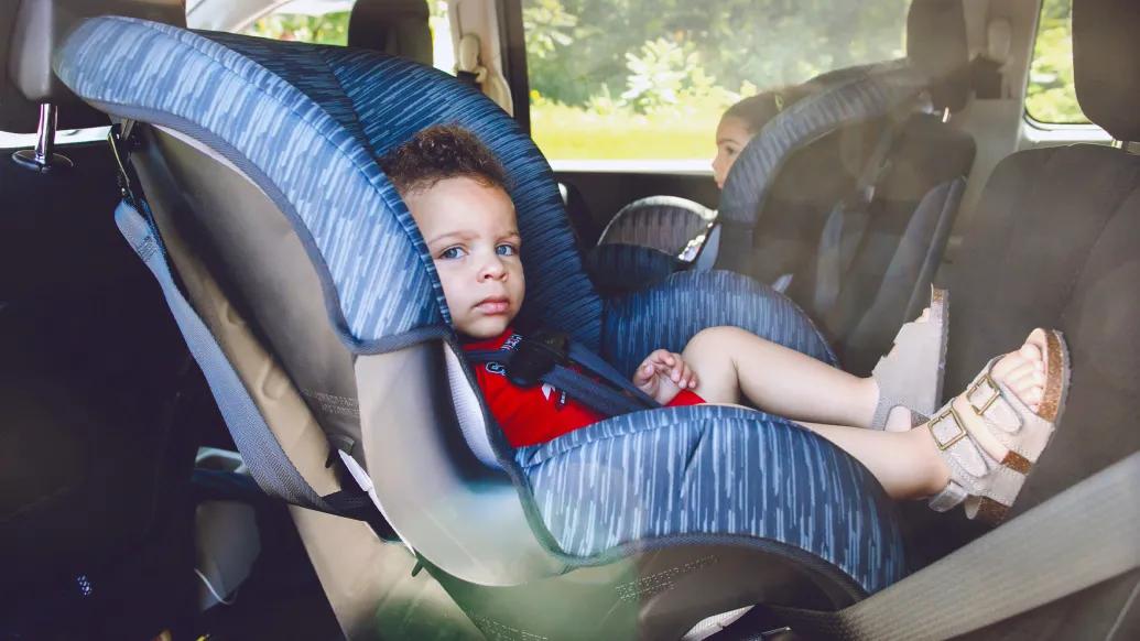 child in back seat of car in car seats