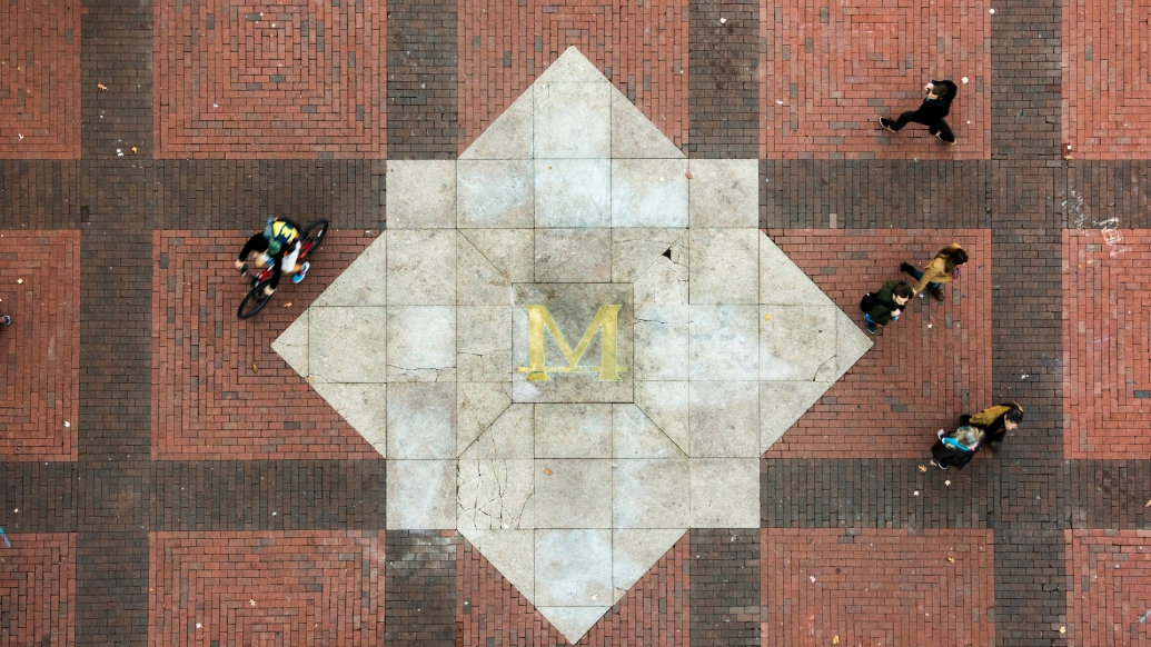 People walking and biking across the U-M diag