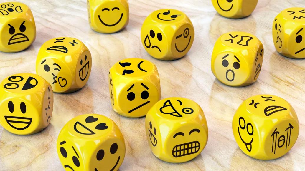 yellow dices with different emotional faces on each side