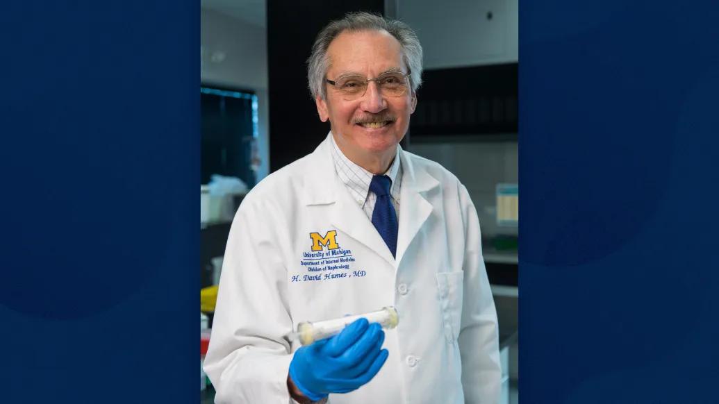 man showing device in his hand smiling with blue gloves on
