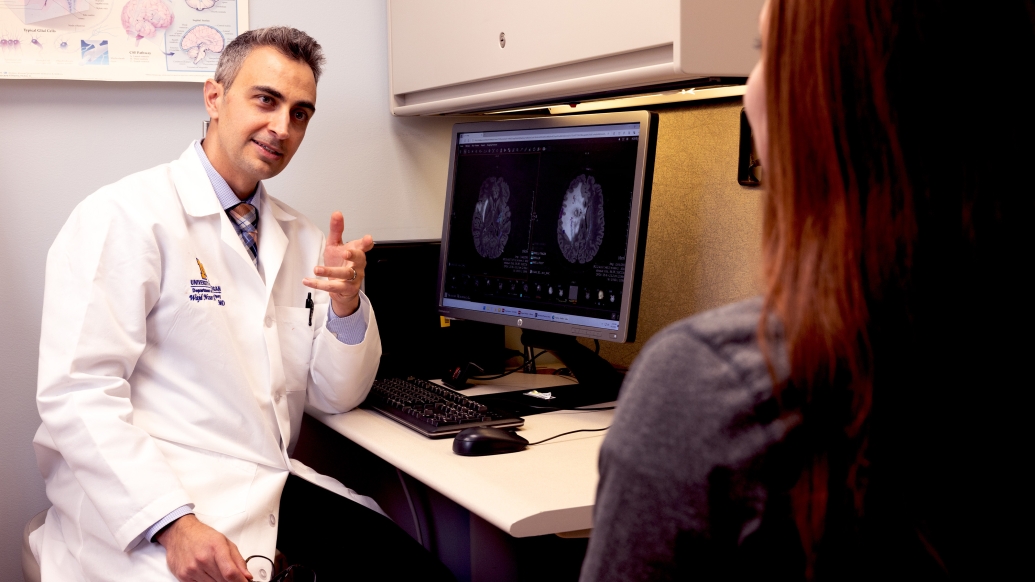 doctor talking to patient in clinic in white coat