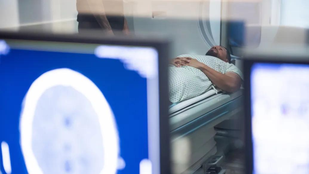 photo of patient in MRI machine with computers closer up seeing scan