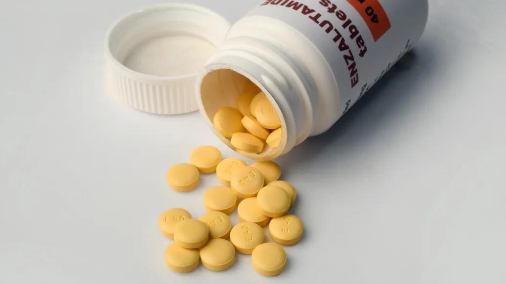 yellow pills spilling out of bottle