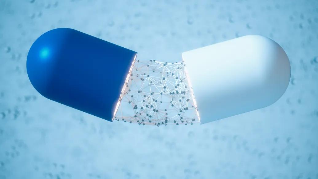 blue and white pill being broken and dots falling out in middle