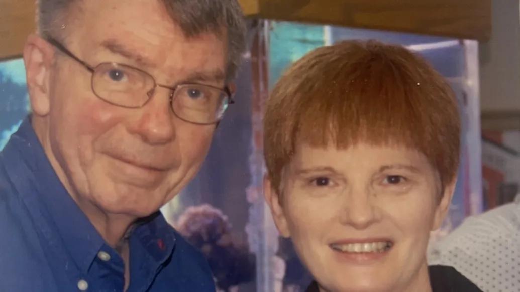 Portraits of Lee Feldkamp and Rose O'Connor standing together. Rose is holding a small glass, suggesting they are at a special event.