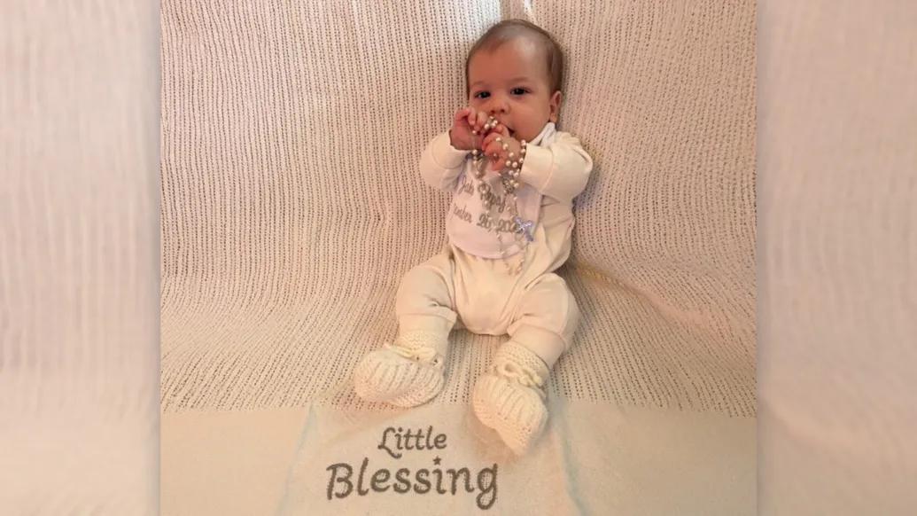 baby on blanket saying little blessing