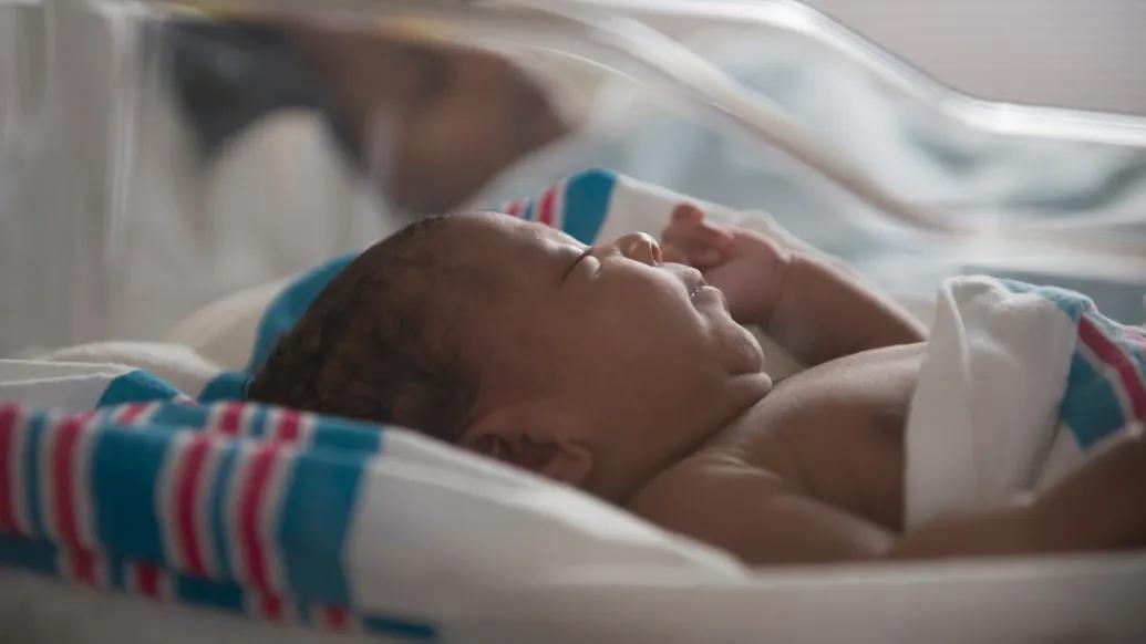 newborn close up in clear bassinet