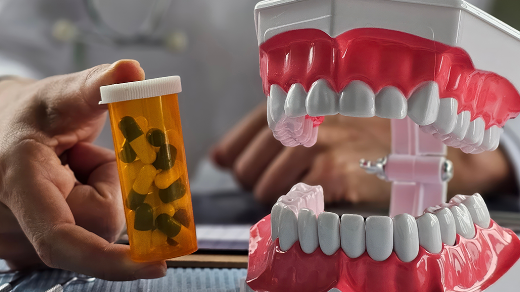pill bottle next to fake mouth of teeth and gums