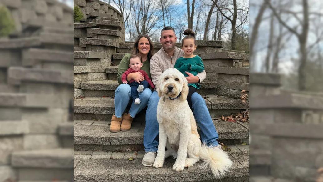 family with dog outside