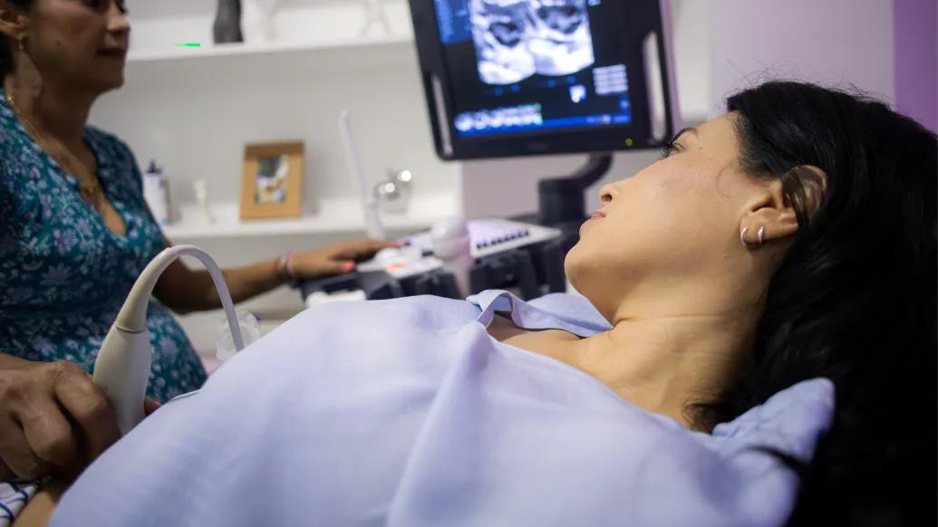 girl laying on chair with scan on screen with provider