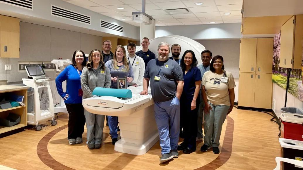 group of medical teammates huddled around the MRI machine 