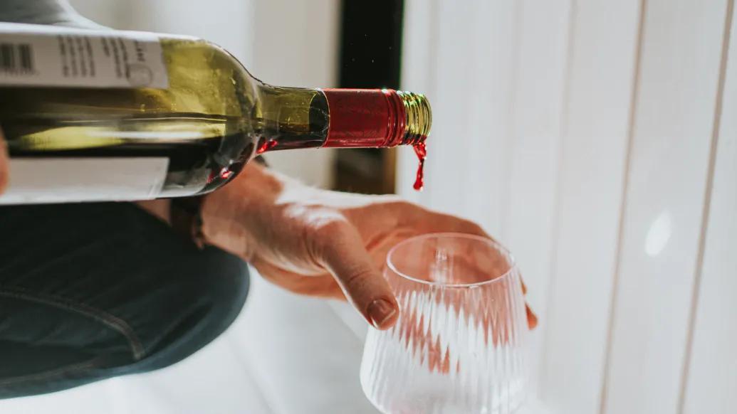 wine being poured into glass 