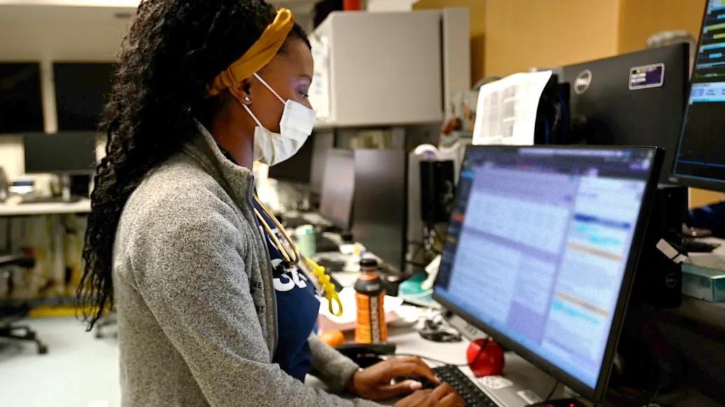 woman looking at screen in office clinical area