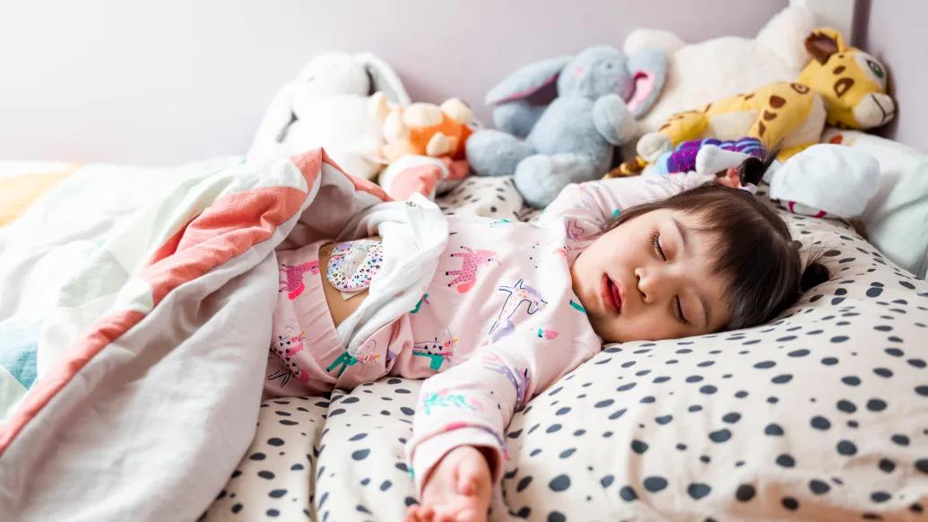 Girl with Down syndrome sleeping in bed