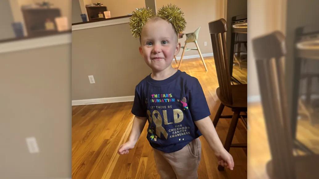 baby with sparkling head ban smiling in house