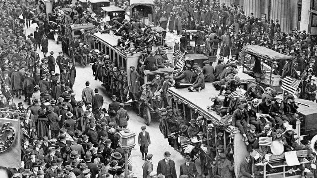 1918 crowd in public area with trolleys in black and white
