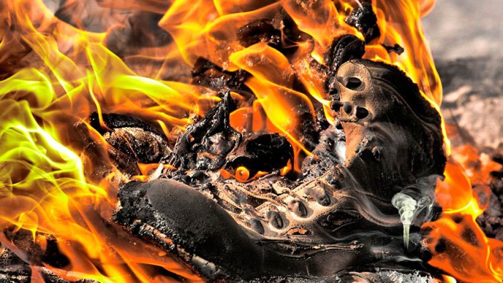 army boot burning fire smoke