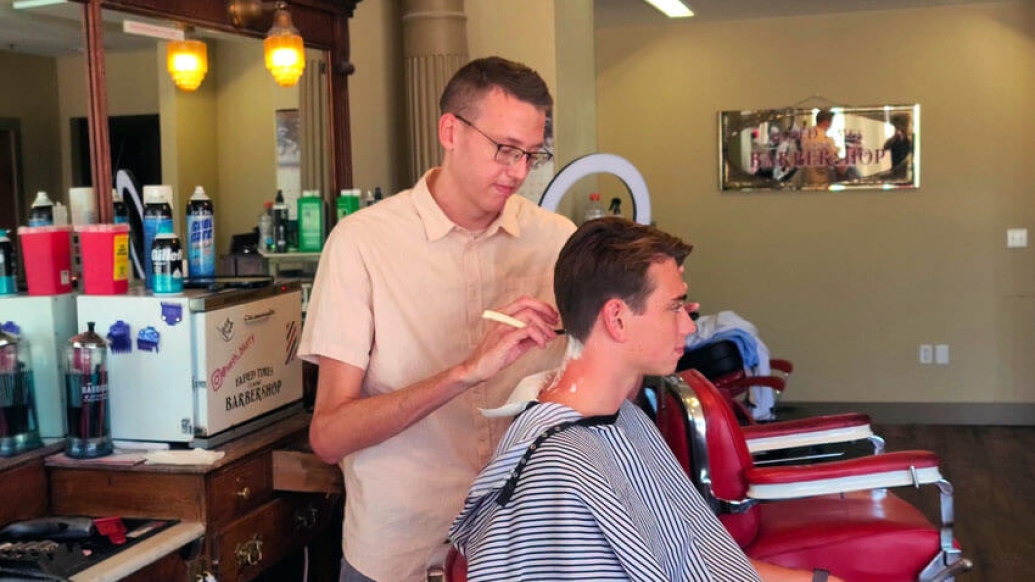 Barber cutting boys hair