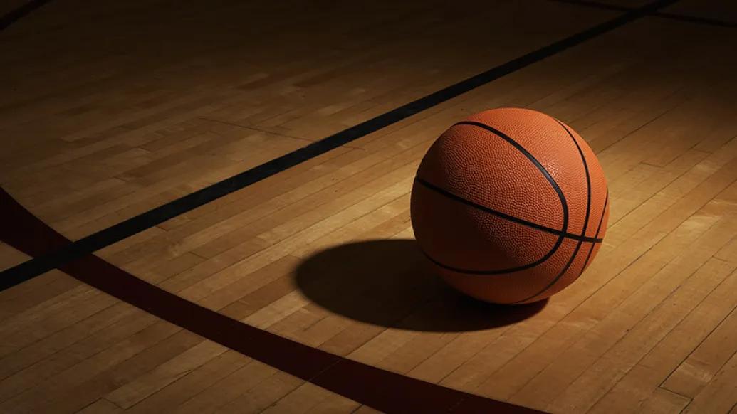 orange basketball shadow on court floor line