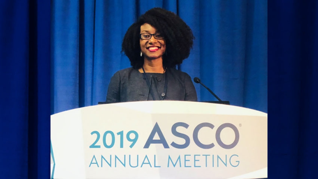 Christina Chapman MD at the speakers podium at the 2019 American Society of Clinical Oncology’s annual meeting