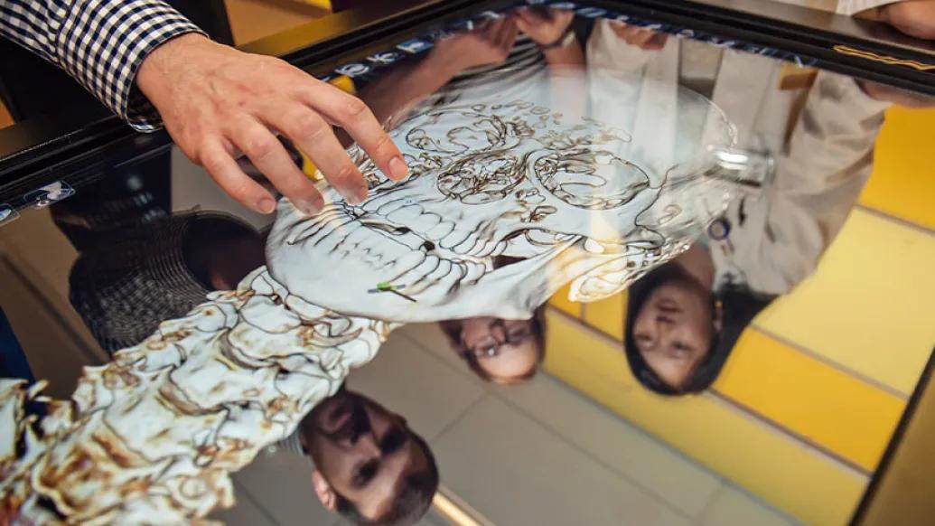 close students standing anatomy table