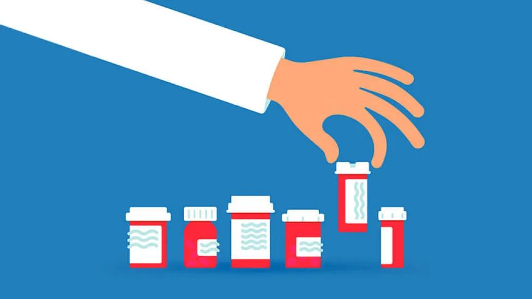 Doctor hand selecting a prescription bottle