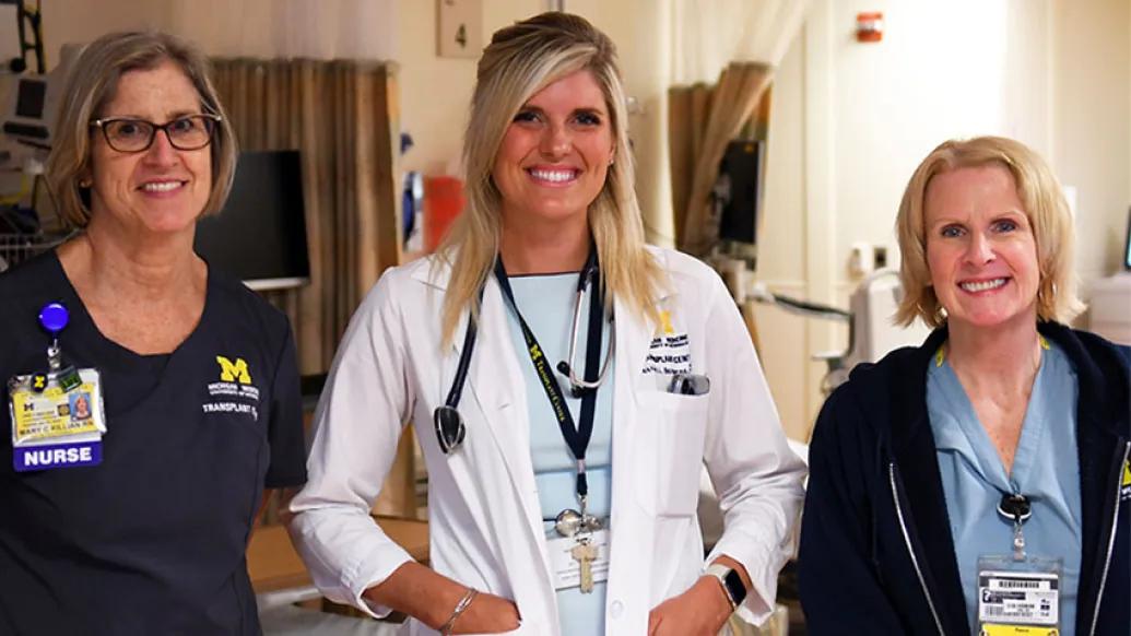 Doctor and nurses smiling in clinic room at hospital