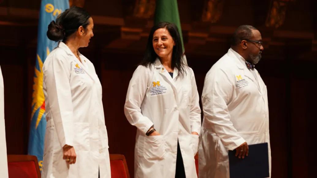 doctors in white coats standing next to each other